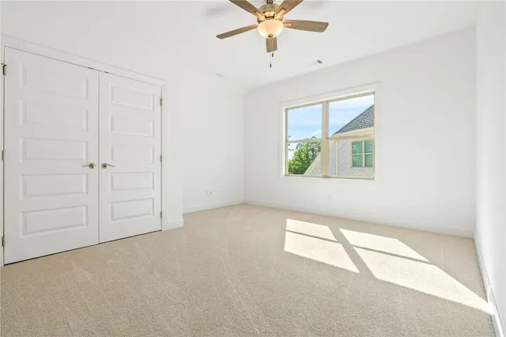 This airy bedroom offers a comfortable and private retreat.