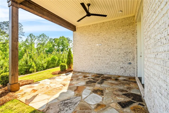 This inviting patio offers a serene outdoor retreat with picturesque views.