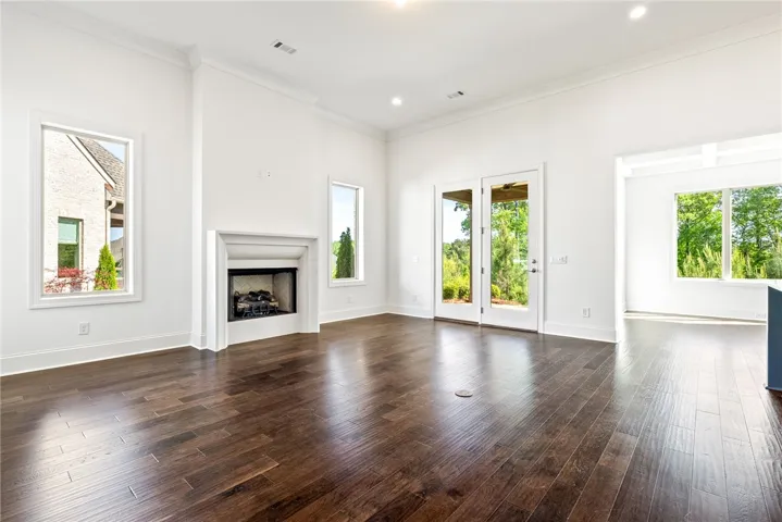 Bright and airy living room with a cozy fireplace and expansive views.