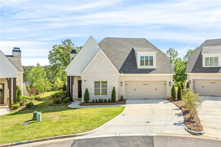 This charming home offers curb appeal with classic architectural elements and an inviting entryway.