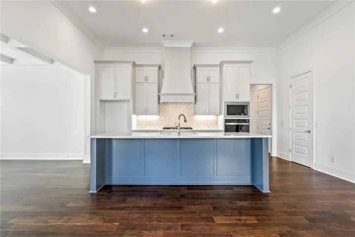 This expansive kitchen features a large island, perfect for gathering and culinary creativity.