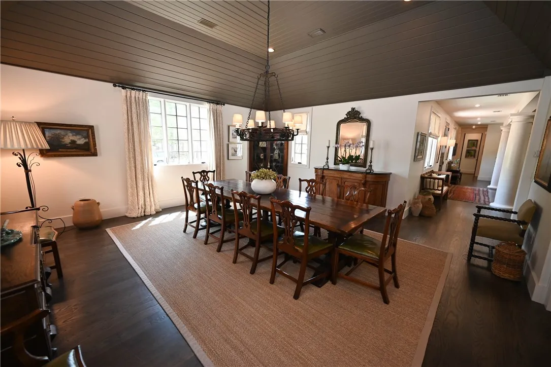 The dining room is connected to the kitchen and main living room, and features a high vaulted ceiling.
