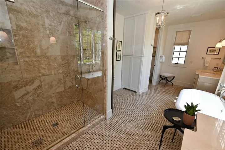 Completed with a spacious marble tile/glass shower!