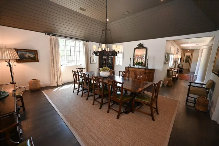 The dining room is connected to the kitchen and main living room, and features a high vaulted ceiling.