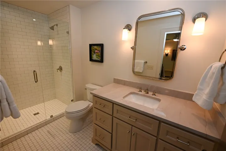 Bedroom 3 en-suite bath with a large tile/glass shower.