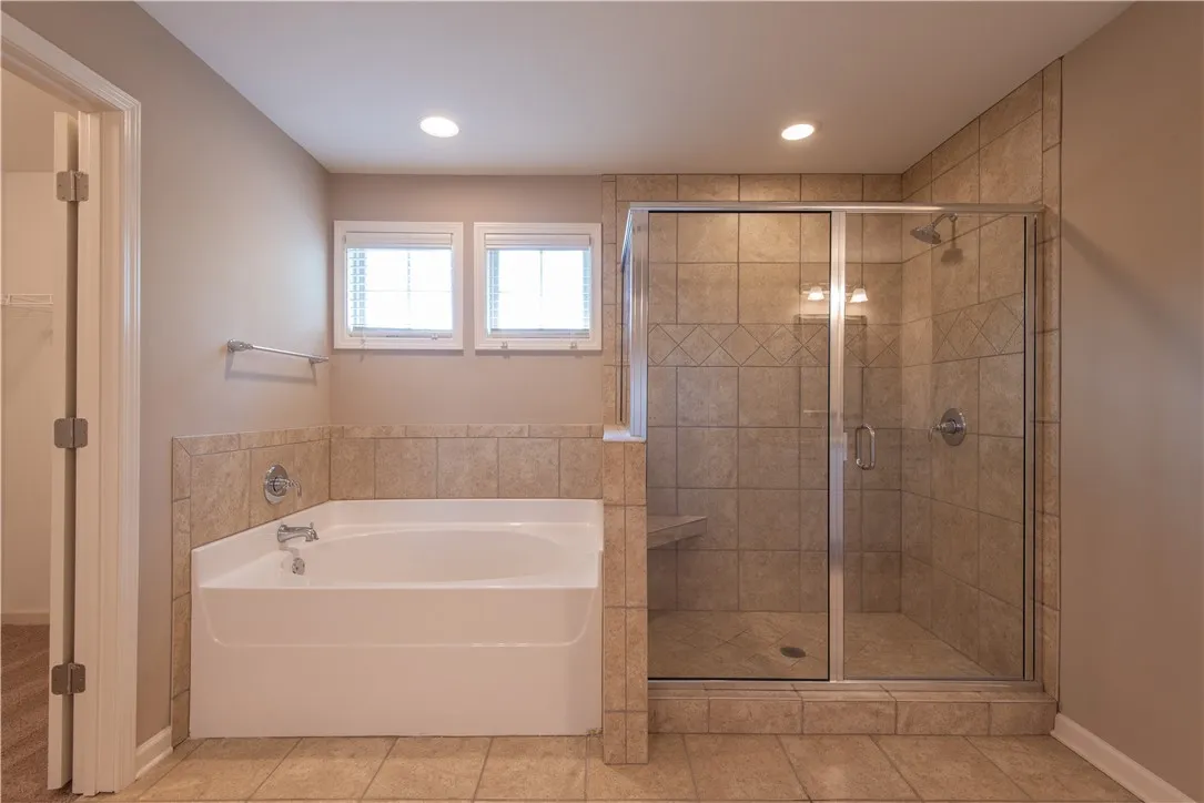 Primary Ensuite bath with garden tub and tiled shower.  (prior to tenants moving in)