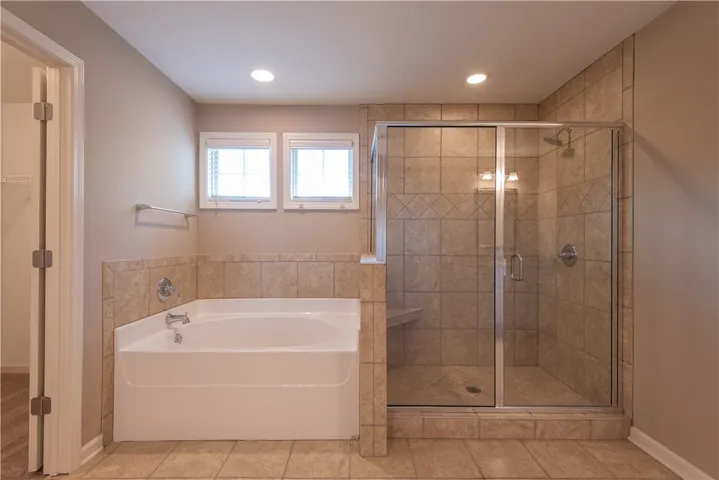 Primary Ensuite bath with garden tub and tiled shower.  (prior to tenants moving in)