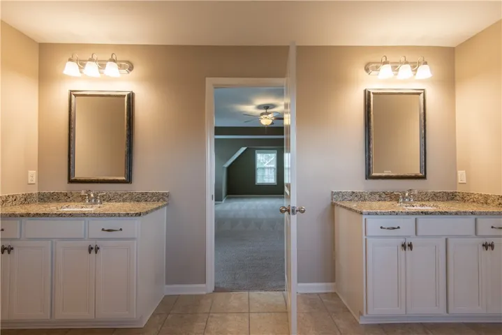 Primary ensuite bath with separate vanities.  (Prior to tenants moving in)