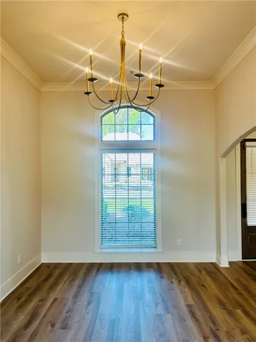 This bright space features a striking chandelier and durable wood flooring.