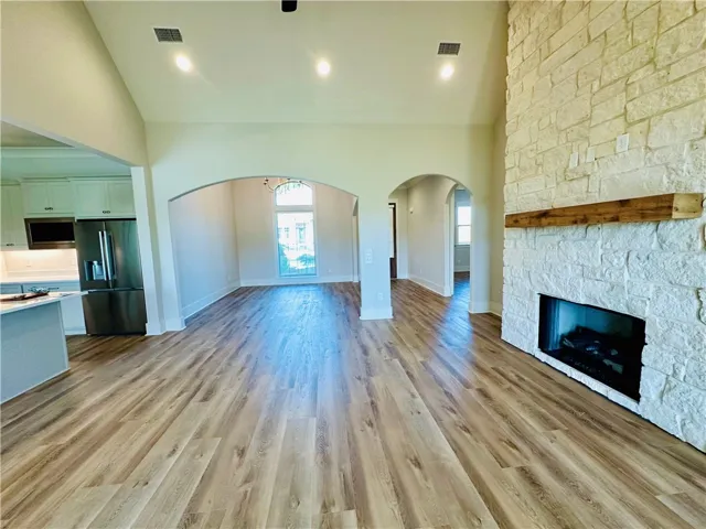 This expansive interior features vaulted ceilings and a captivating fireplace, perfect for gatherings.
