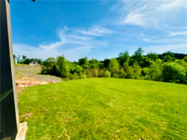 Rolling green landscape offering serene natural vistas and an expansive outdoor experience.