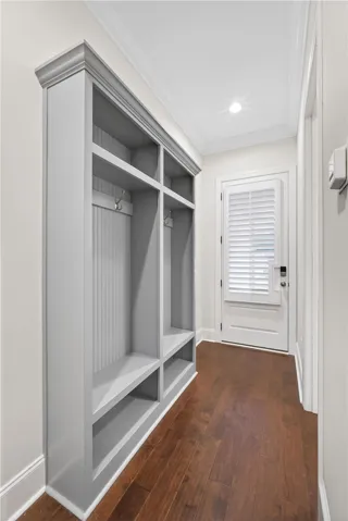 Custom built-in mudroom storage with ample shelving and hanging space offers everyday convenience.