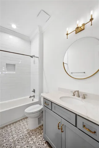 A well-appointed bathroom features a crisp white subway-tiled shower alongside a vanity with a sophisticated marble countertop.