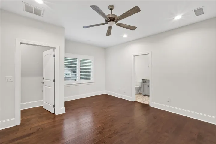 Hardwood floors and a ceiling fan create a comfortable atmosphere in this well-lit space.