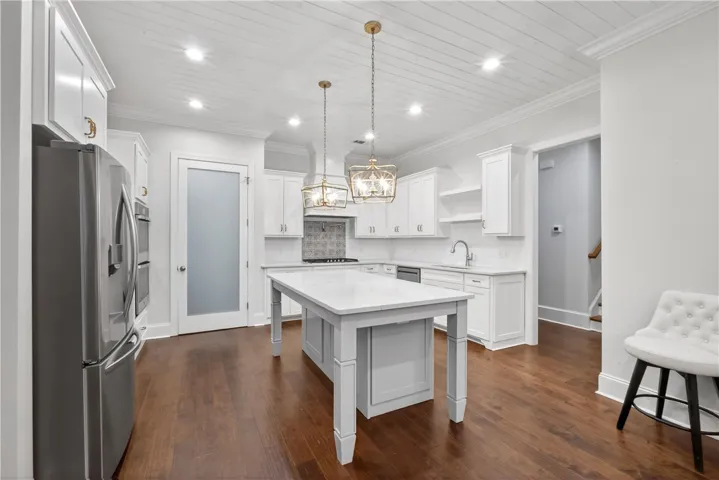 Culinary delights await in this bright kitchen, complete with a generous island and ample cabinetry.