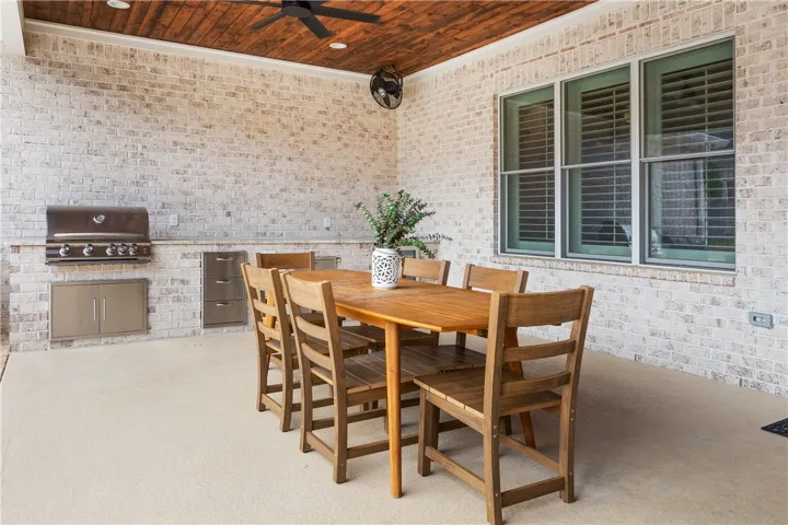 An inviting outdoor living space features an integrated barbecue station, ideal for al fresco dining.