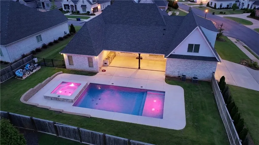 An inviting pool and spa beckon in the fenced backyard of this charming residence.
