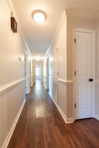 Hallway leading to 3 bedrooms and primary suite