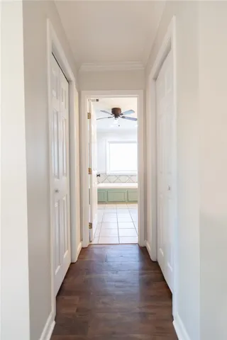Hallway in primary leading to bathroom and closets