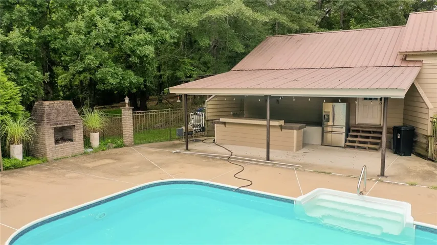 Outdoor kitchen and fireplace at pool