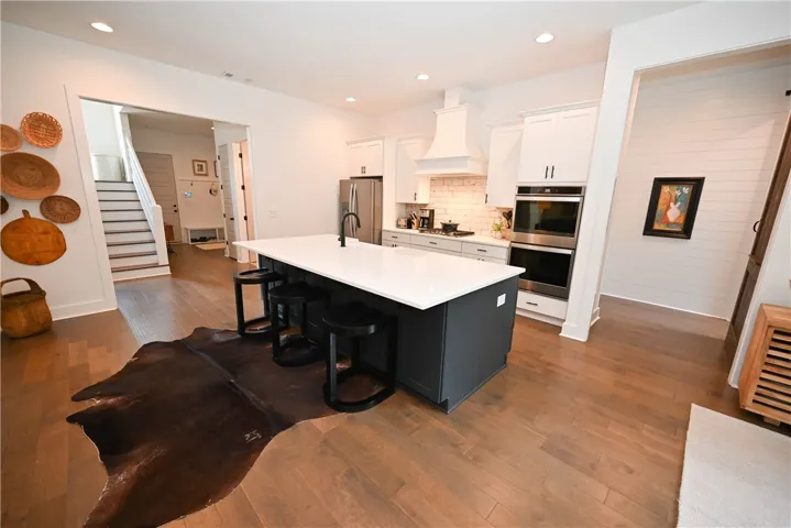 Open kitchen. Back left: mudroom (with adjacent laundry, full bath, & bedroom).