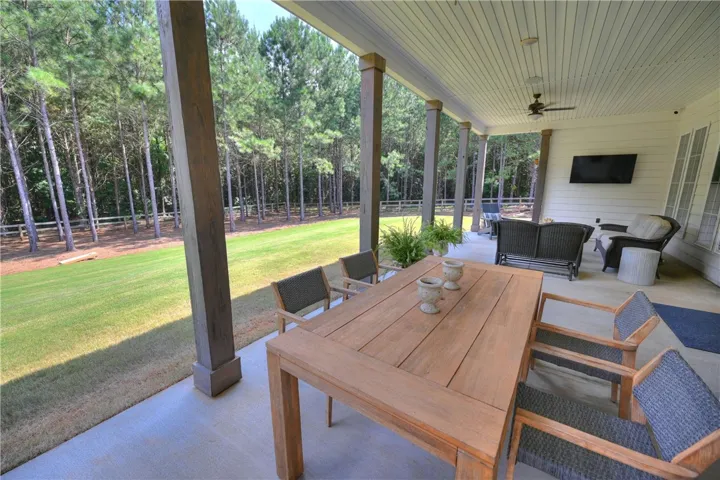 Breezy covered porch with integrated media wiring - perfect for entertaining!