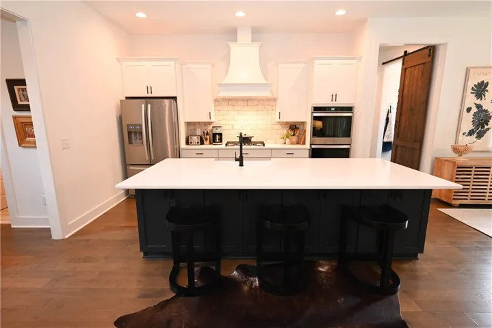Kitchen with (amazing!) walk-in pantry behind the barn door in back right & breakfast area far right.