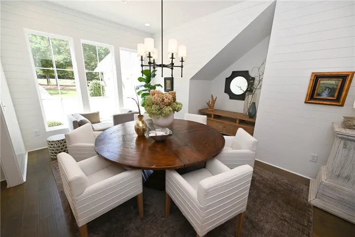 Dining room with large windows, shiplap walls, & fun architectural details.
