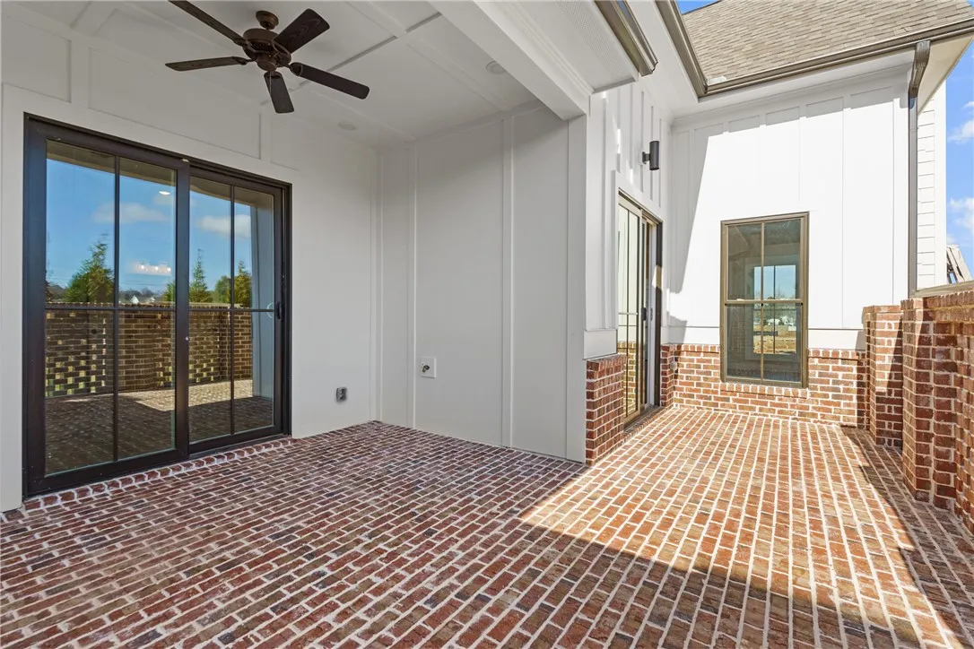 This inviting patio features brick flooring, creating an ideal outdoor living space for relaxation and enjoyment.