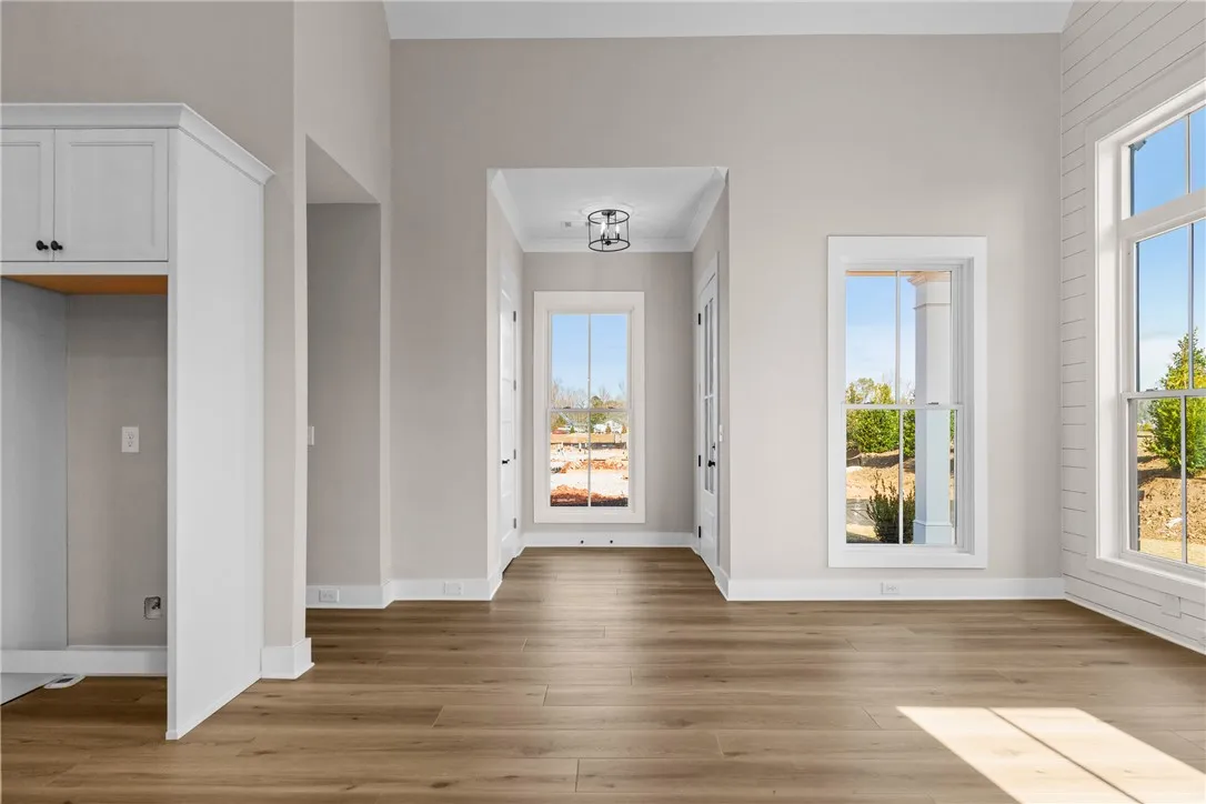 Bright and airy interior space featuring abundant natural light and sleek wood flooring.