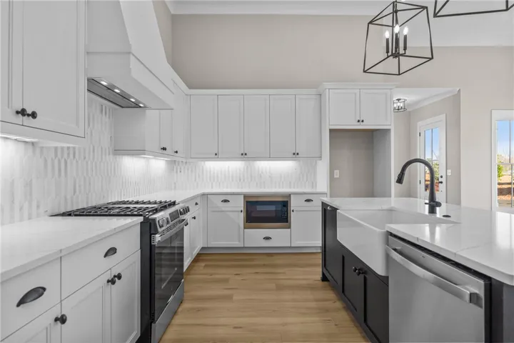 This sleek kitchen features modern appliances, clean lines, and ample counter space for culinary endeavors.