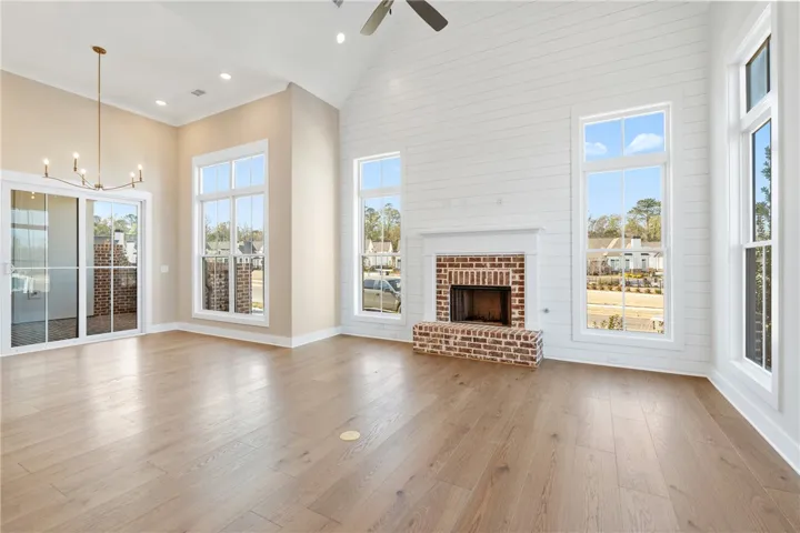 This expansive living area features towering ceilings and an inviting fireplace, perfect for gatherings.