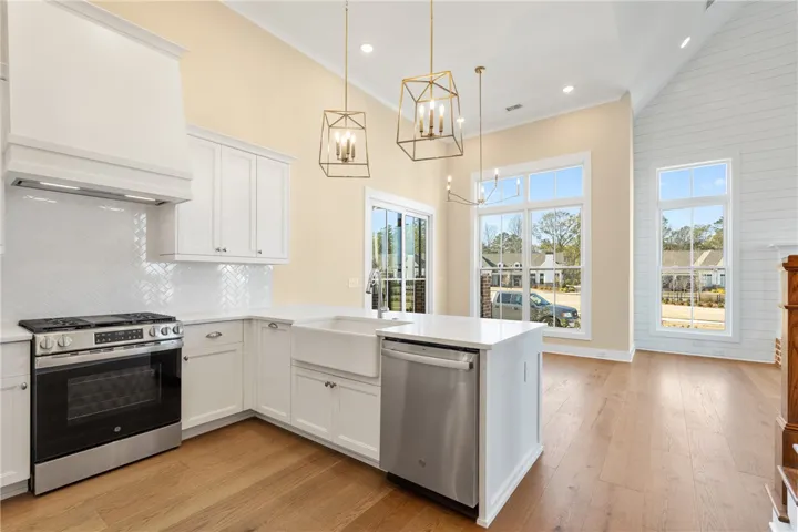 This spacious kitchen offers a bright open-concept design and high ceilings.