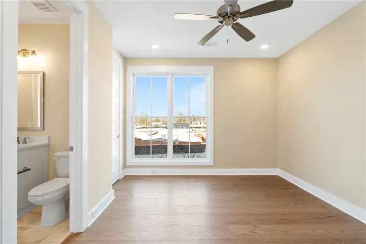 This airy room features hardwood floors and a bright window, perfect for any use.