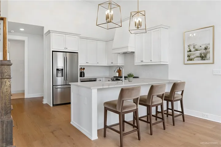 This bright kitchen features clean lines and an inviting island, perfect for entertaining.