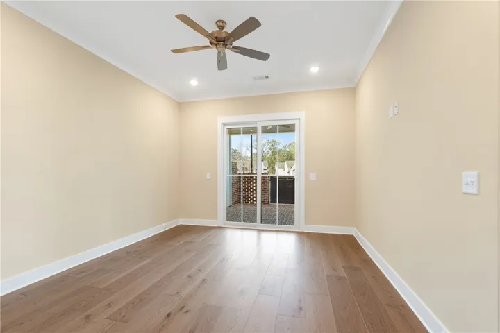 This versatile room features hardwood floors, recessed lighting, and direct access to an outdoor patio.
