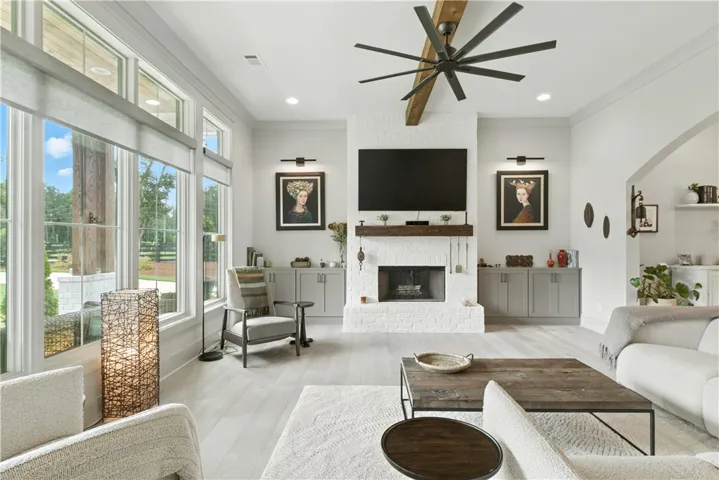 Stunning wood-burning fireplace with gas starter  flanked with builtin cabinets. The sconces will highlight the new owners favorite pieces of Art.