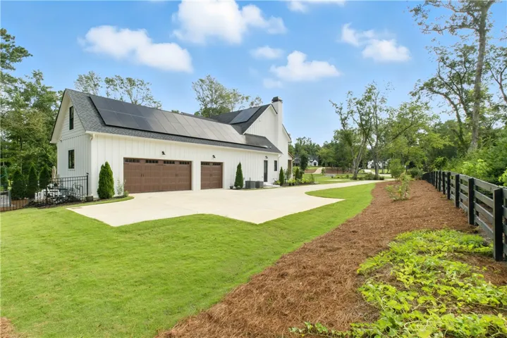 Three car garage with electric car hook up. Solar Panels significantly reduce utility bills