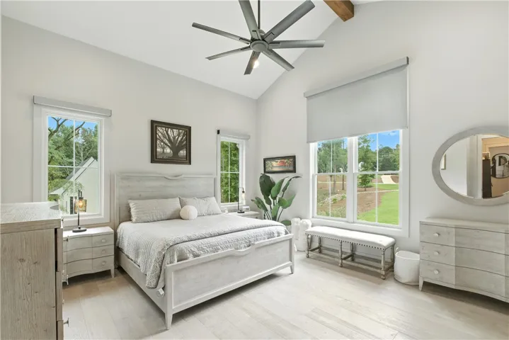 Beautiful Vaulted ceiling in Primary bedroom with automatic black out shades