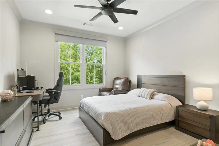 Bedroom 4 on the second level has spectacular views of the pool and creek below