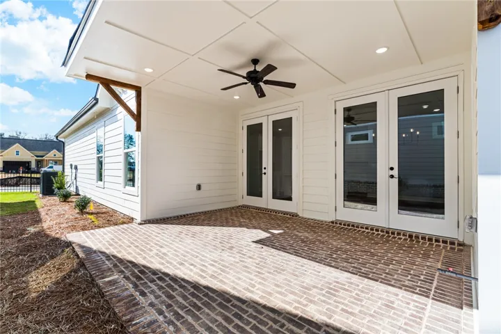 This inviting covered patio offers brick flooring and direct access to the outdoors.