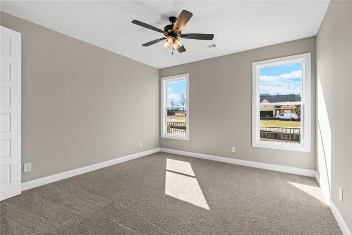 This airy bedroom offers a peaceful retreat with ample natural light.
