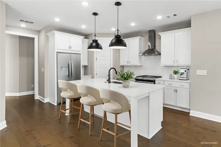 Bright and open kitchen with modern design elements, featuring a large island and ample counter space.
