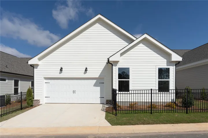 This newly constructed home showcases contemporary design and a neatly manicured lawn.