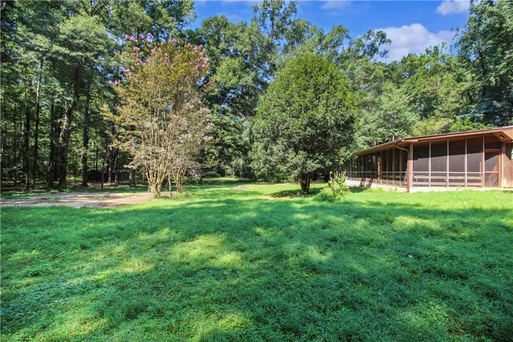 Large Screend In Porch of the Cabin and Lush Green Yard