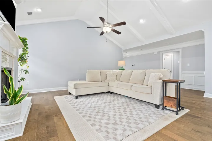 The vaulted ceiling gives the living room a spacious, airy feel, while the gas fireplace and wood floors add warmth and character.