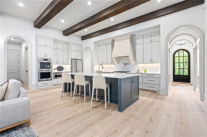 This gourmet kitchen features a spacious island, premium appliances, and charming architectural details.