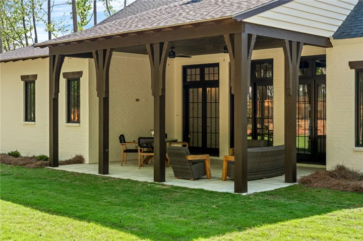 This inviting patio with a covered porch offers an ideal outdoor living space for relaxation.