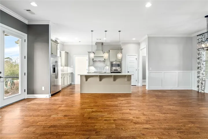 Open concept with tasteful central island with serene color scheme