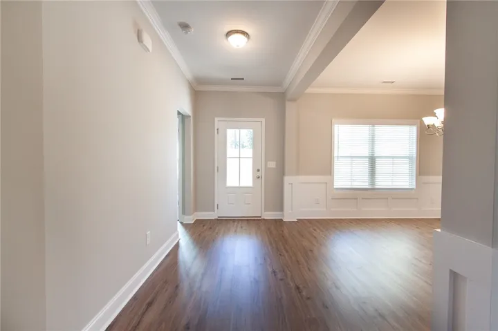 Main entrance with dining room to the right and front bedroom to the left